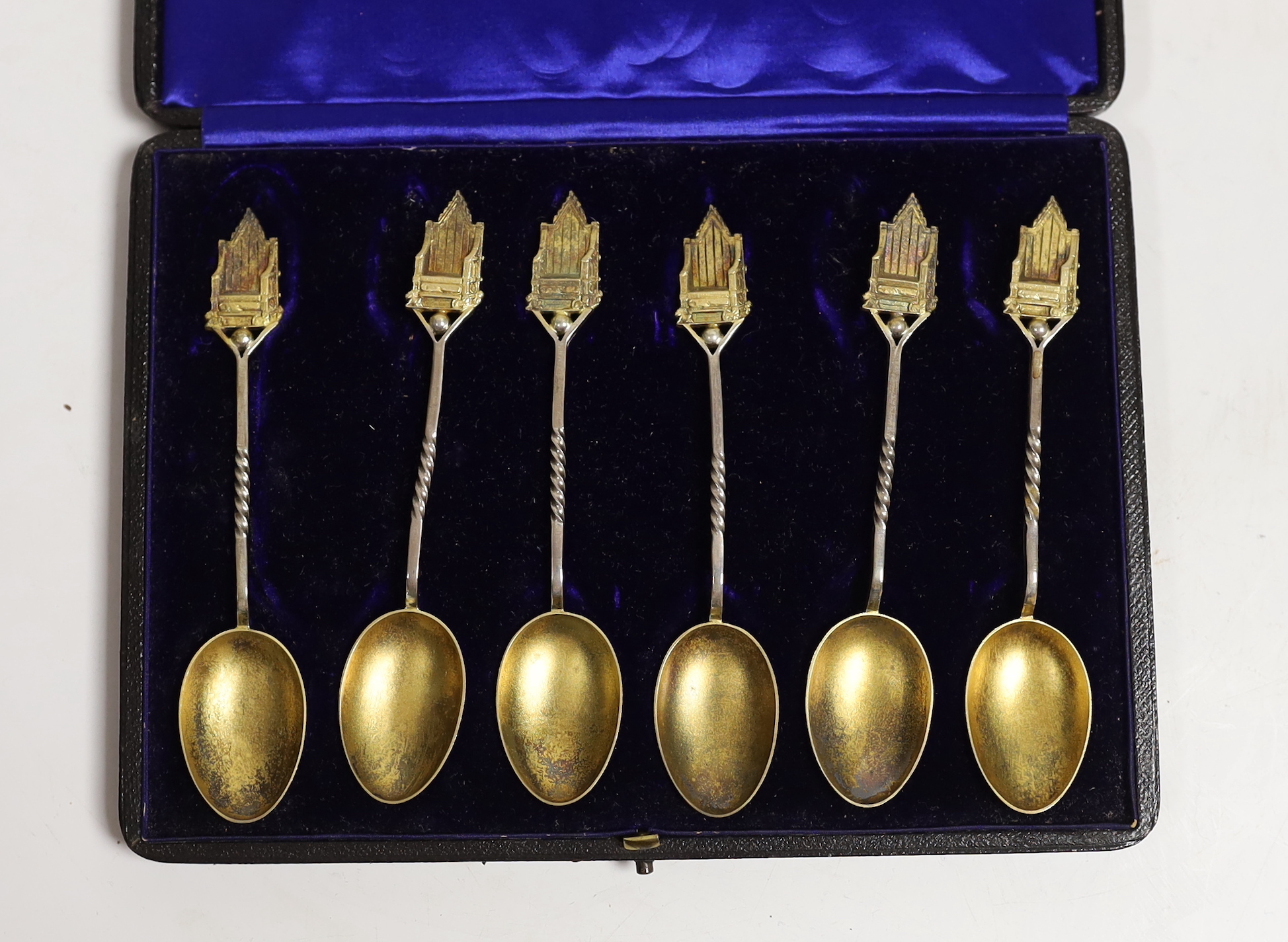 A late Victorian demi fluted silver hot water pot, Charles Favell & Co, Sheffield, 1898, gross weight 11.8oz and a cased set of six silver gilt teaspoons with throne terminals.